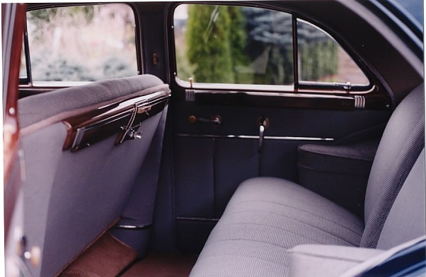 Rear interior view, with restored cloth seats and door panels finished in the Same broadcloth material as was used in the original car.
