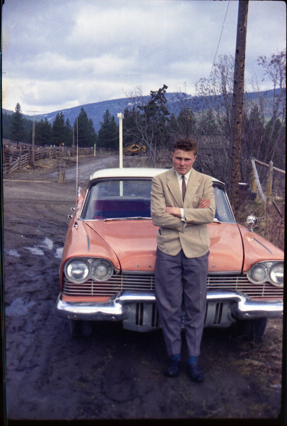 Gordon standing in front of coral 1957 Plymouth Plaza